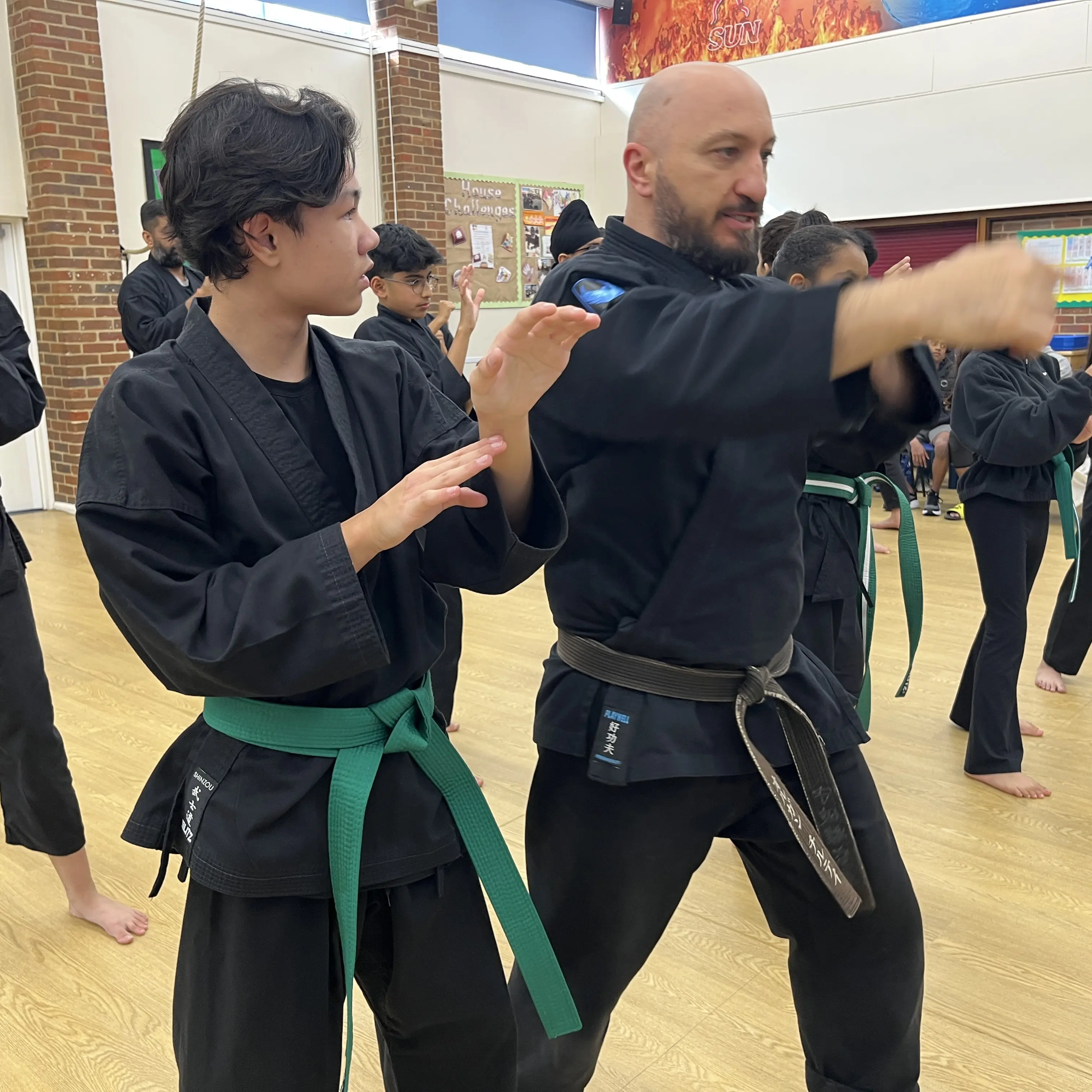 Olgun Tiltay of  Shuhari Self Defence teaching basic karate technique to a student in Maidenhead